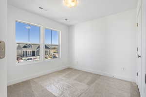 Unfurnished room with light colored carpet