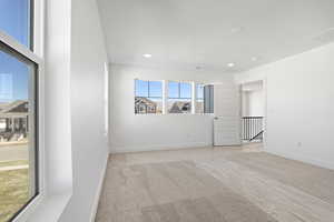 Spare room with light carpet and recessed lighting
