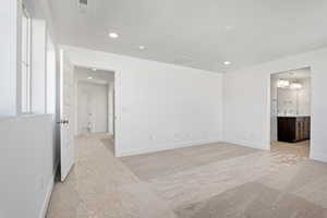 Unfurnished room featuring light colored carpet and recessed lighting