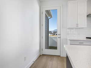 Doorway to outside with wood finished floors and a mountain view
