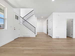 Entrance foyer featuring stairway, light wood-type flooring, and recessed lighting