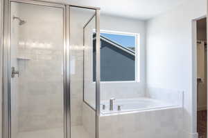 Full bath with a shower stall and a garden tub