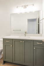 Bathroom featuring vanity and light wood finished floors