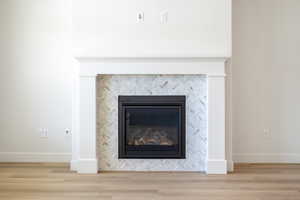 Detailed view of a fireplace and wood finished floors