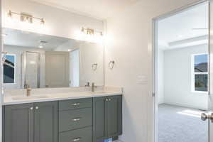 Bathroom with double vanity and a stall shower