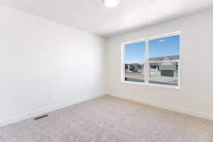 Empty room featuring baseboards and carpet floors