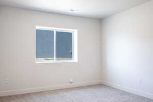 Spare room with carpet floors and baseboards