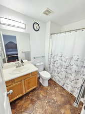 Full bath with vanity, ensuite bathroom, and curtained shower