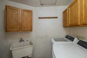 Laundry room featuring washing machine and dryer and cabinet space