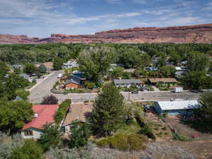 Aerial view of property's location with nearby suburban area and mountains