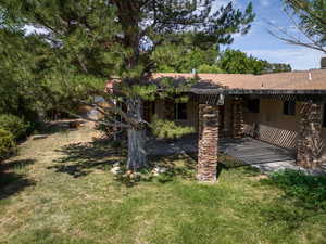 View of grassy yard featuring a patio area