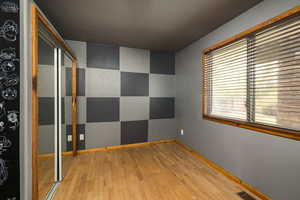 Unfurnished room featuring light wood-type flooring and baseboards