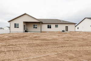 Rear view of property with a patio area, a shingled roof, and entry steps