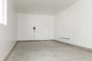 Garage featuring baseboards