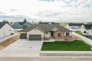 Modern inspired farmhouse with board and batten siding, a shingled roof, a residential view, a garage, and a front lawn