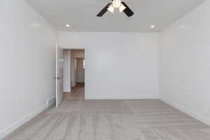 Unfurnished room with light carpet, recessed lighting, and a ceiling fan