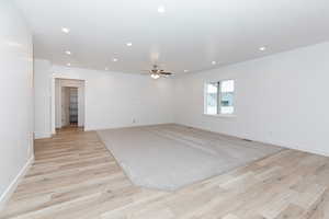 Empty room featuring recessed lighting, light wood-style floors, and a ceiling fan