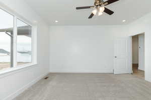 Unfurnished room featuring light colored carpet, recessed lighting, and a ceiling fan
