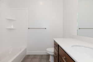 Bathroom featuring vanity and dark tile patterned flooring