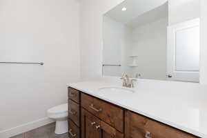 Bathroom featuring vanity, light tile patterned floors, and recessed lighting