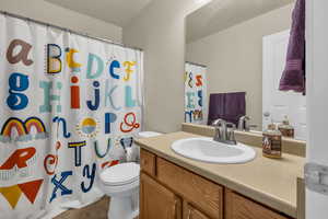 Full bath with vanity, tile patterned floors, and a shower with curtain