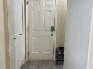 Doorway featuring wood finished floors