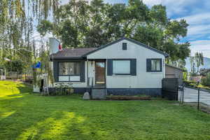 View of front of house with entry steps, a chimney, and brick siding