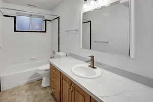 Bathroom with shower / washtub combination and vanity