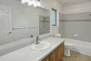 Full bath featuring bathing tub / shower combination, vanity, and a chandelier