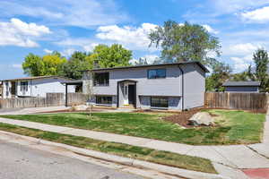 Raised ranch featuring brick siding