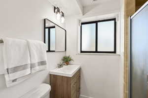 Bathroom featuring vanity and a stall shower
