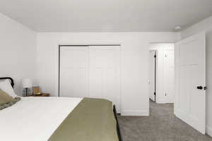 Bedroom featuring carpet and a closet