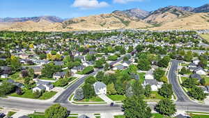 Aerial overview of property's location featuring mountains and nearby suburban area