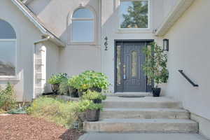 View of exterior entry with stucco siding