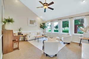 Living room with high vaulted ceiling, light carpet, a ceiling fan, and recessed lighting