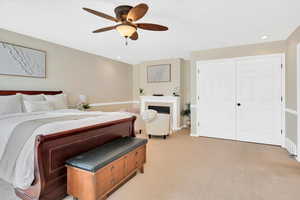 Bedroom featuring light colored carpet, a ceiling fan, and recessed lighting