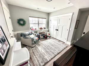 Living room featuring wood finished floors and a textured ceiling