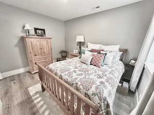 Bedroom featuring light wood-style floors and baseboards