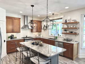 Kitchen featuring tasteful backsplash, plenty of natural light, a kitchen bar, light stone countertops, and recessed lighting