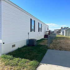 View of side of home with crawl space and a central air condition unit