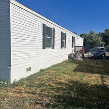 View of property exterior with a yard