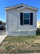 View of side of home featuring a lawn