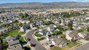 Aerial overview of property's location featuring nearby suburban area and a mountainous background