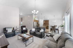 Living room featuring a chandelier and high vaulted ceiling