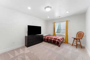 Bedroom featuring light carpet and recessed lighting