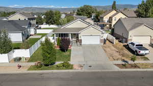 View of front of home with a residential view, an attached garage, driveway, a porch, and board and batten siding