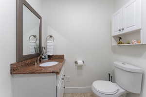 Half bathroom featuring vanity and light tile patterned flooring