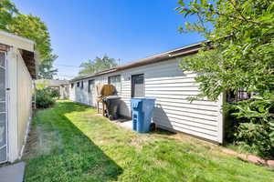 Rear view of house featuring a lawn
