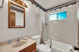 Full bathroom with shower / bath combo with shower curtain and vanity