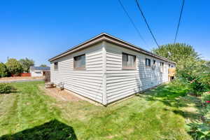View of home's exterior with a yard